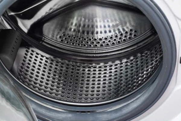 The washing machine drum inside close up