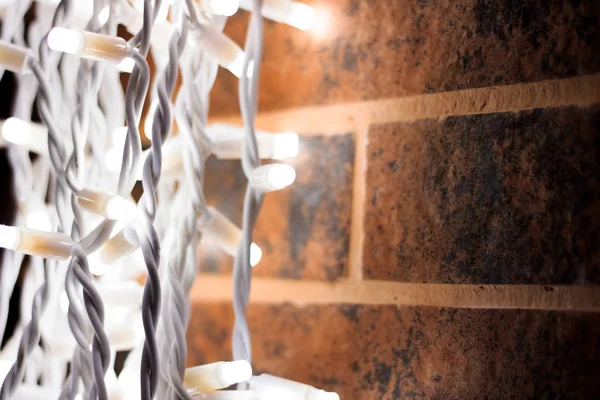 Белые лампочки гирлянды на кирпичной стене — стоковое фото