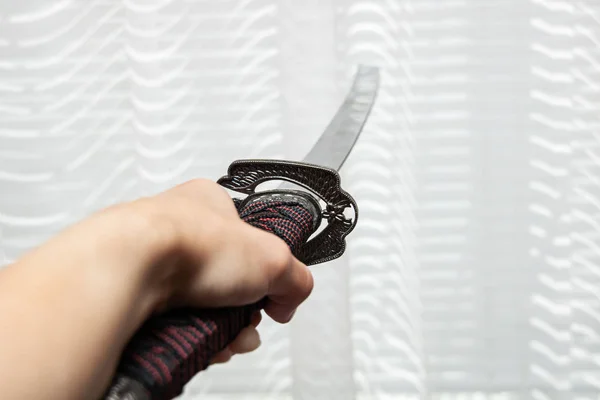 Samurai sword in hand close up, with copy space