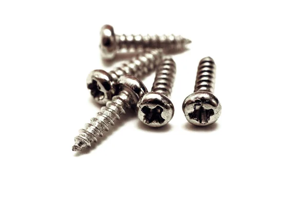 A pile of small metal bolts isolated — Stock Photo, Image
