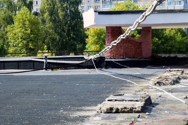 Electric wires on the flat roof of the building