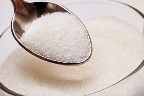 Sugar in sugar bowl and spoon close up — Stock Photo, Image