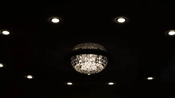 Large retro glass chandelier on ceiling in dark — Stock Photo, Image