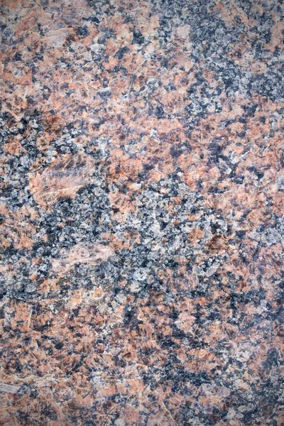 Bright red black granite stone close up, background or texture