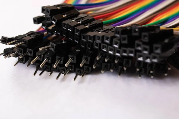 Multicolored computer wires on a white background close up