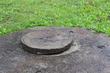 Çimenlikteki kapağın üstü beton kaplı.