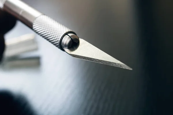 Sharp blade of a metal scalpel closeup