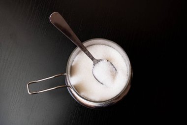 Şeker ve kaşık, teneke kutunun yanında