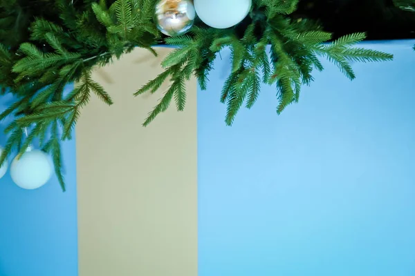 tree branches with blue baubles, snowflakes isolated on white - horizontal border . Border of Christmas tree branches on blue background