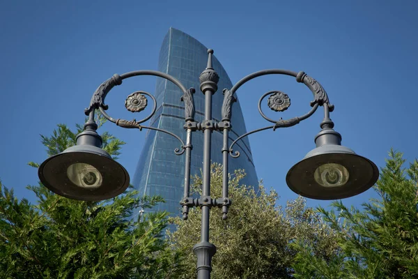 an image of street light on blue sky . vintage lamppost . modern street lamp shines against a background of blue sky at sunset . Lamppost with the background of the sky