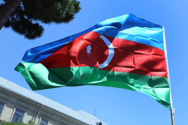 Azerbaijan flag in Baku, Azerbaijan. National sign background. Red Green Blue flag. Azerbaijan national flag with Crescent moon. Azerbaijan tradition patriotic. Flags waving wind