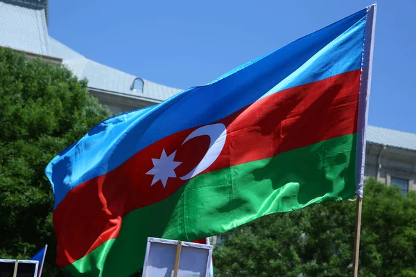 Azerbaijan flag in Baku, Azerbaijan. National sign background. Red Green Blue flag. Azerbaijan national flag with Crescent moon. Azerbaijan tradition patriotic. Flags waving wind