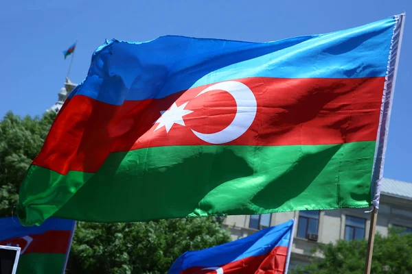 Azerbaijan flag in Baku, Azerbaijan. National sign background. Red Green Blue flag. Azerbaijan national flag with Crescent moon. Azerbaijan tradition patriotic. Flags waving wind