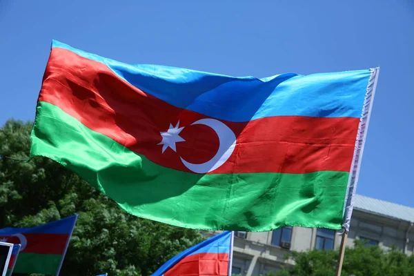 Azerbaijan flag in Baku, Azerbaijan. National sign background. Red Green Blue flag. Azerbaijan national flag with Crescent moon. Azerbaijan tradition patriotic. Flags waving wind