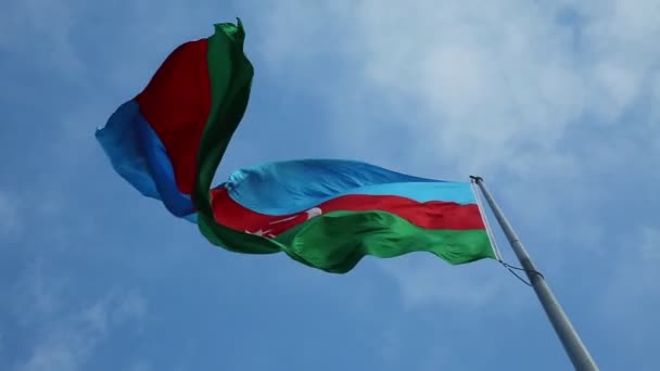 Groot en mooi wapperende vlag van Azerbeidzjan met solide blauwe hemelachtergrond. — Stockvideo