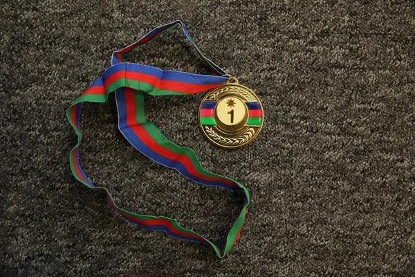 Sport trophy. Gold medal on black background . Gold medal on black background . Gold, medal with numbers One. Sport trophy. Azerbaijan medal .