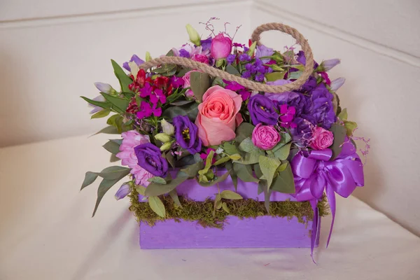Beautiful wedding colorful purple bouquet for bride. Beauty of colored flowers. Flowers backgrounds . Four-legged rose bush . Beautiful bunch of purple flowers with white, red and yellow flowers .