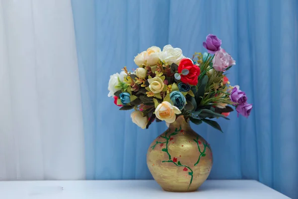 Vaso com belo buquê de flores aster na mesa contra fundo azul. Espaço para SMS. Uma taça de água. vasos de flores com flores roxas douradas no fundo do céu  . — Fotografia de Stock