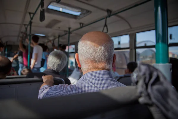s the main mass transit passengers in the bus. People in old public bus, view from inside the bus . People sitting on a comfortable bus in Selective focus and blurred background.