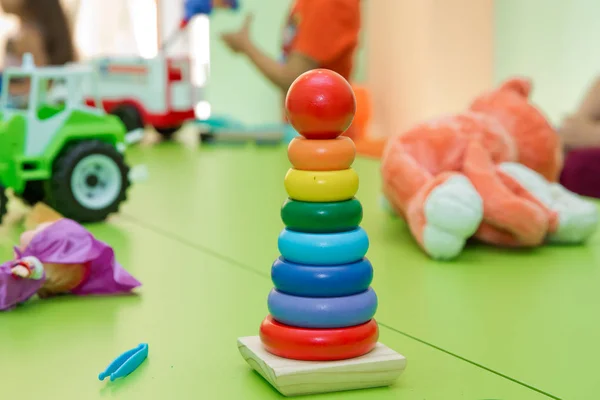 Zabawka dla niemowląt i małych dzieci, aby z radością nauczyć się umiejętności mechanicznych i kolorów. Zabawki edukacyjne dla małych dzieci, pierścienie chwytania, izolowane na żółto. — Zdjęcie stockowe