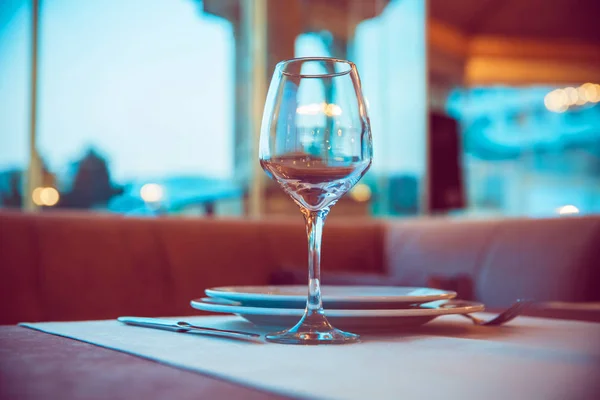 Selective focus. Empty glasses set in restaurant . Closeup image of empty glass ar blurred restaurant background. Close up picture of empty glasses in restaurant.