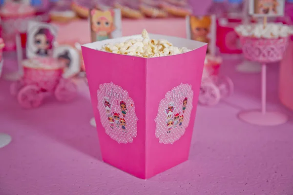 Eine große klassische Schachtel Theater-Popcorn isoliert auf rosa. einfache Dekoration von Babynamen mit lol-Cartoons in der Stadt Azerbaijan. dekorierter lol Tisch zum Geburtstag . — Stockfoto