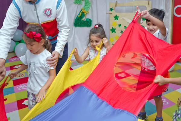 Birthday two years in the kindergarden . Children's birthday with animators . Happy group of children at a birthday celebration dressed in the style of paw patrol with an animator . — Stock Photo, Image