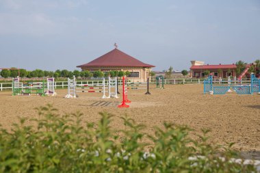 Atlamak için arka plan olarak tahta engeller. Binicilik engellerinin renkli bir fotoğrafı. At atlama yarışması için boş alan. Antrenman sahasında atlama direklerinin görüntüsü.
