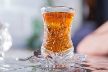 Black turkish tea in pear shape glass, traditional Azerbaijani aromatic tea in armudu cup . Tea in Azerbaijani traditional armudu pear-shaped glass . Azerbaijan black tea .white sugar cubes