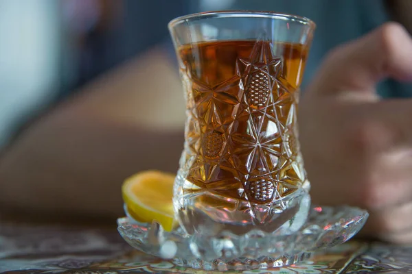 Black turkish tea in pear shape glass, traditional Azerbaijani aromatic tea in armudu cup . Tea in Azerbaijani traditional armudu pear-shaped glass . Azerbaijan black tea .white sugar cubes