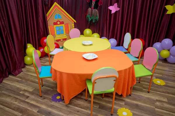 School kindergarden nursery dining room . children\'s furniture and toys in kindergarten . empty tables . refectory of a school for children with chairs and tables without people .y-free stock