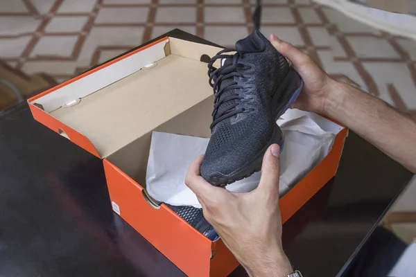 Opening the box of a new pair of shoes