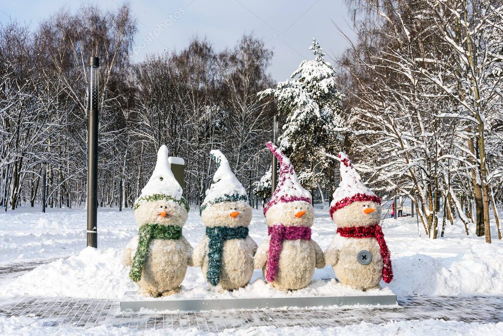 Four snowmen in the park Kuzminki in Moscow. Russia. Beautiful winter forest. Scene of winter snow landscape.