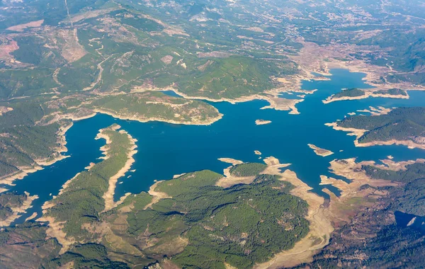Aerial view, birds eye view of the lake among wooded hills