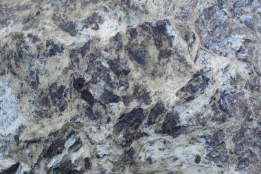 Gri ve mavi taşın kaba, soyut desenli yüzeyi