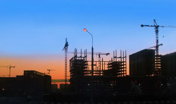Building site and cranes on sunset
