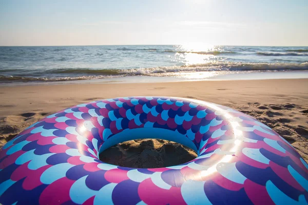 Inflatable children's swimming circle on the beach by the sea