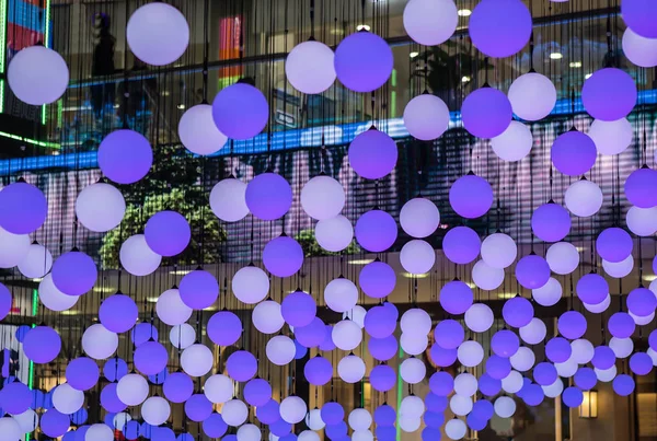 Blue balls hanging from ceiling as interior decoration inside shopping mall.