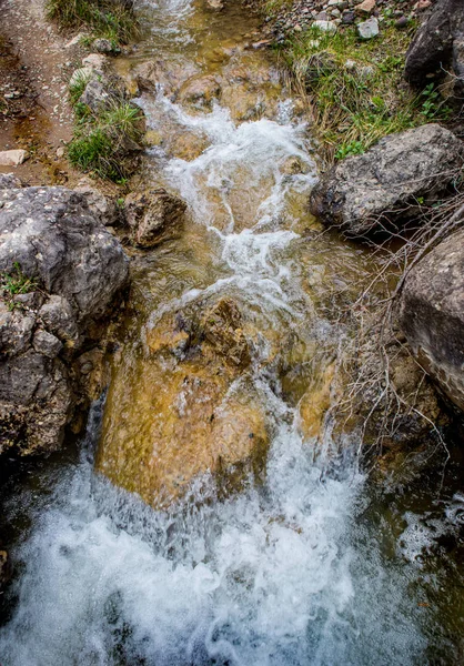 Поток воды между скалами горного ручья — стоковое фото