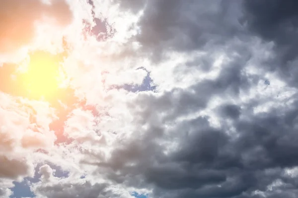 Темне небо з сонцем і хмарами — стокове фото