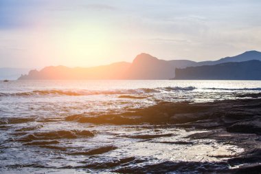 Gün batımında denizde Pelerin