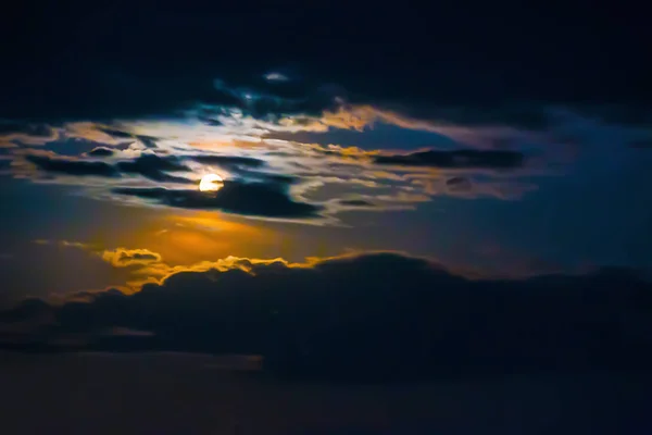 Night sky with moon and clouds.