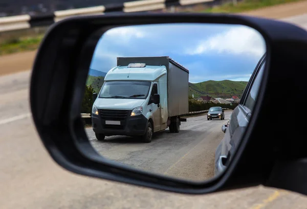 Вид через зеркало заднего вида автомобиля на движение c — стоковое фото