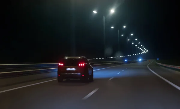 Car moves at high speed on a suburban highway — Stock Photo, Image