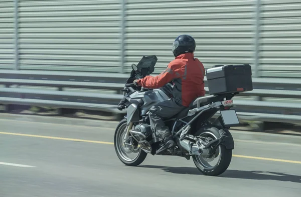 Pengendara sepeda motor pada sepeda motor bergerak di kota — Stok Foto