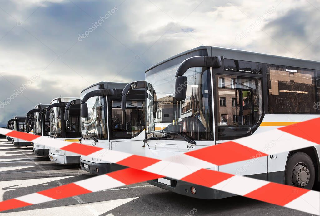 Restriction of public transport, quarantine, virus, isolation, variable tape. Buses in the parking lot.