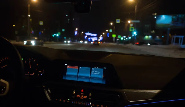 car moves on a street in a city on a winter night. Car inside view