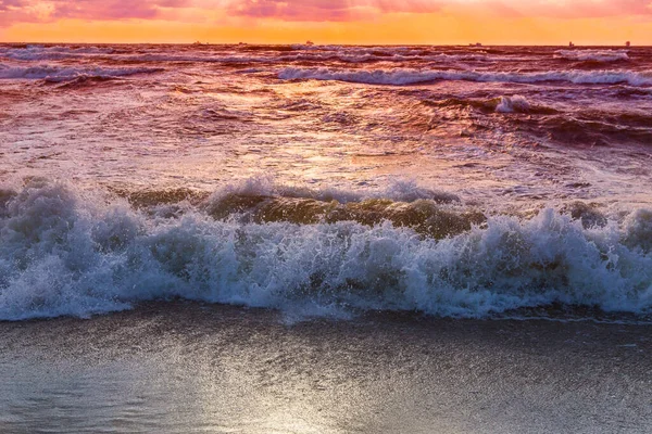 Beautiful storm on the sea at sunset