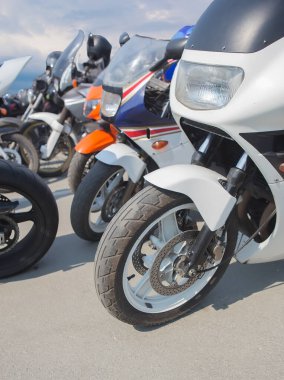 Yoldaki motosikletler bulutlu bir gökyüzüne karşı