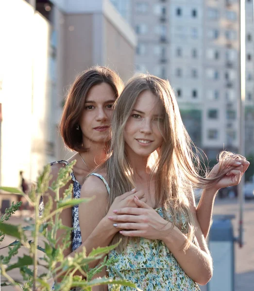 portrait of nice girls in the sunset street